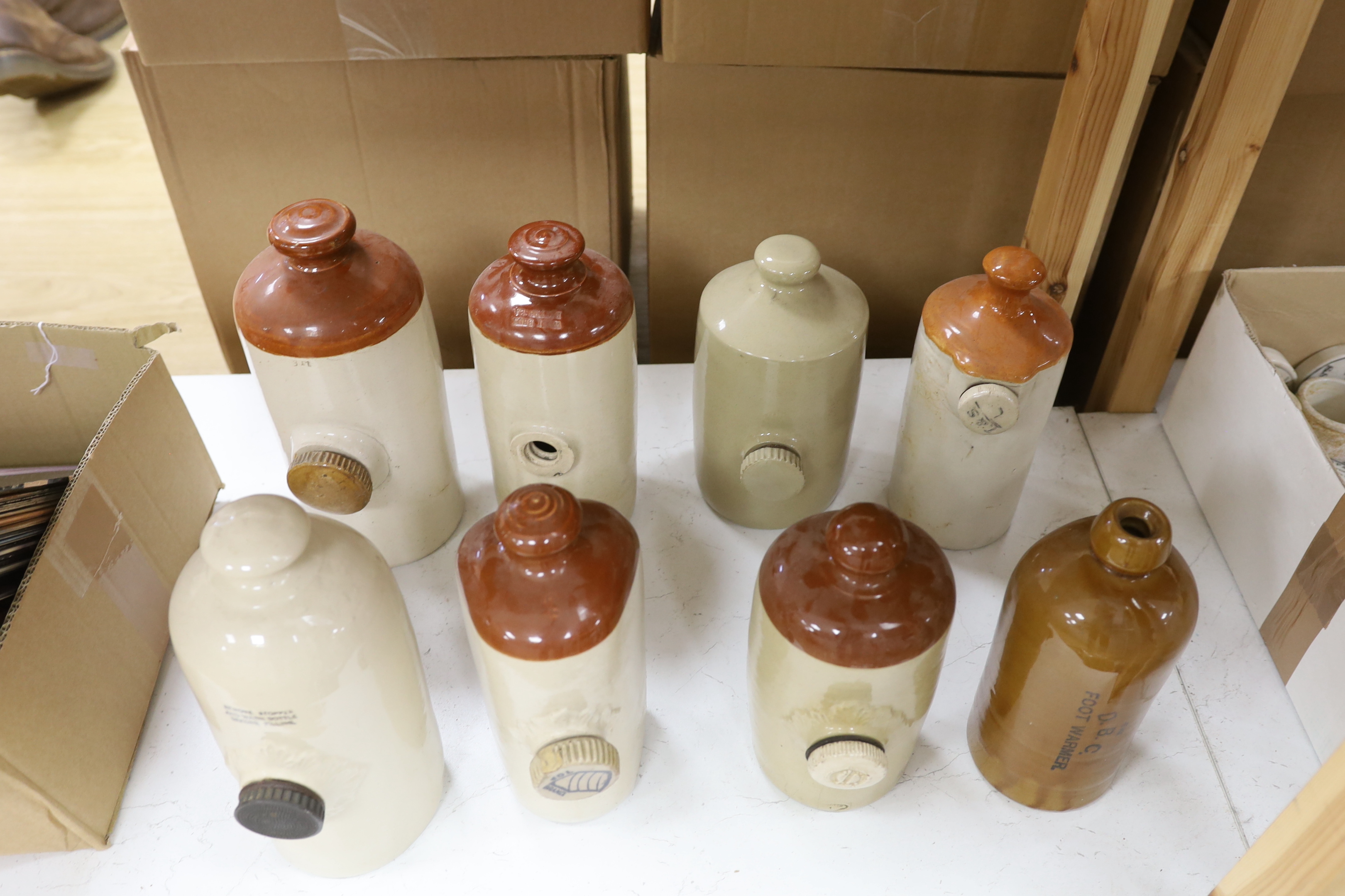 Eight various stoneware hotwater bottles, early 20th century, largest 30cm high